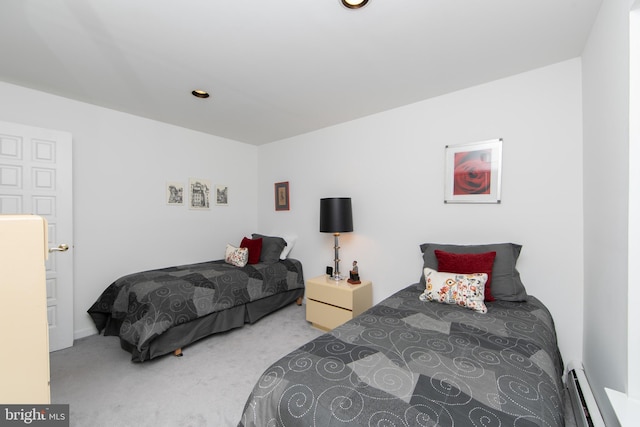 bedroom featuring a baseboard heating unit and carpet