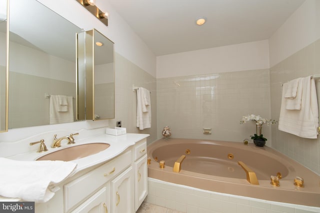 full bath with vanity and a whirlpool tub