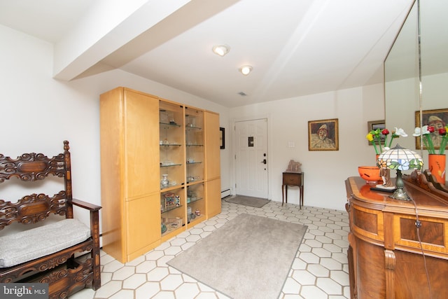 foyer featuring a baseboard heating unit