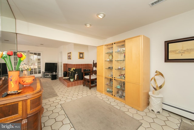 living room with visible vents and a baseboard radiator