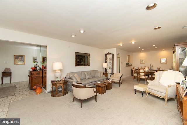 carpeted living room featuring tile patterned flooring and recessed lighting