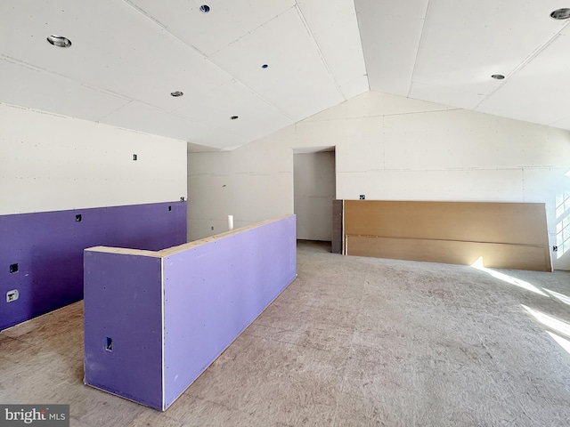 empty room featuring vaulted ceiling