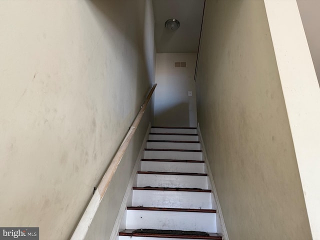 staircase featuring visible vents