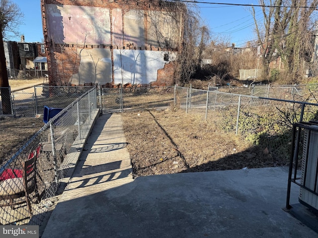 view of yard featuring a gate, central AC unit, and fence