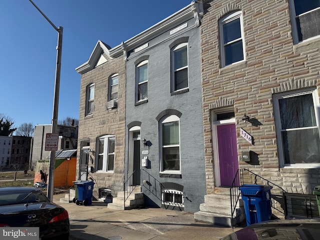 view of property featuring cooling unit and entry steps