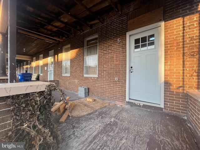 view of exterior entry with brick siding