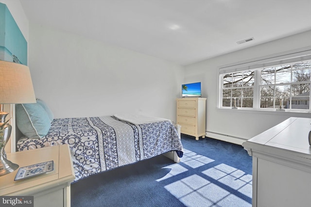 bedroom with baseboard heating, dark carpet, and visible vents