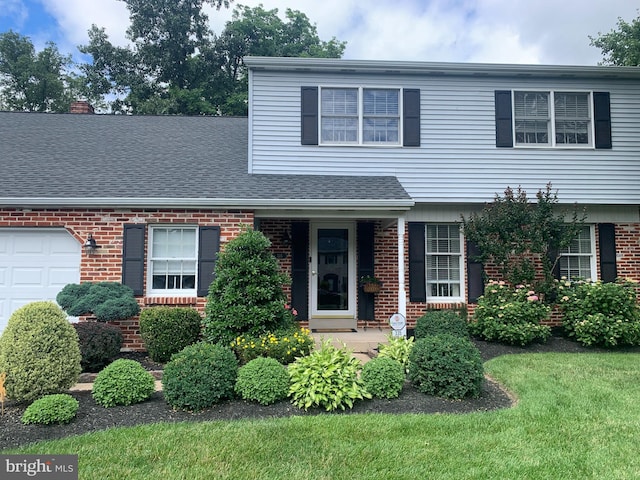 view of front of property featuring a front yard, a garage, brick siding, and a shingled roof