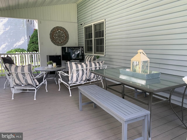 wooden terrace featuring outdoor dining area