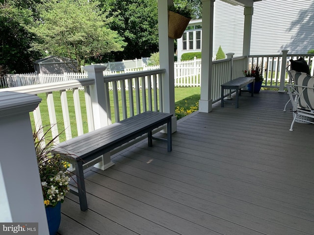 wooden terrace with a fenced backyard and a yard