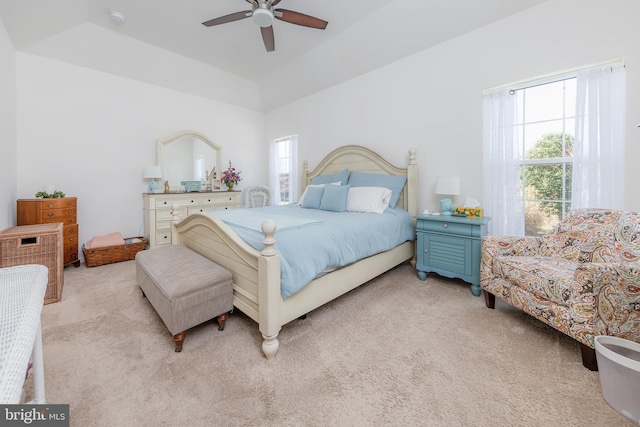 bedroom featuring multiple windows, light colored carpet, and ceiling fan