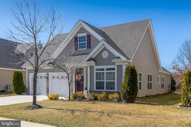 view of front of house with a front lawn, concrete driveway, and roof with shingles