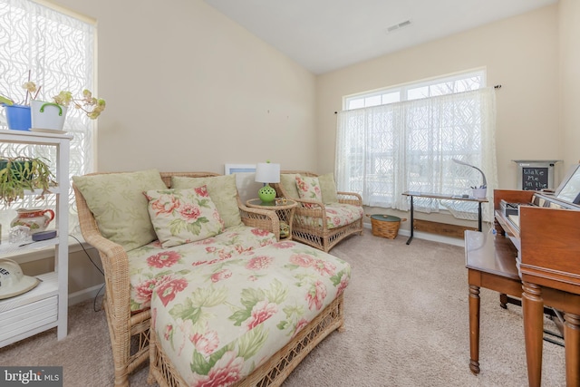 sitting room featuring vaulted ceiling, baseboards, visible vents, and carpet floors