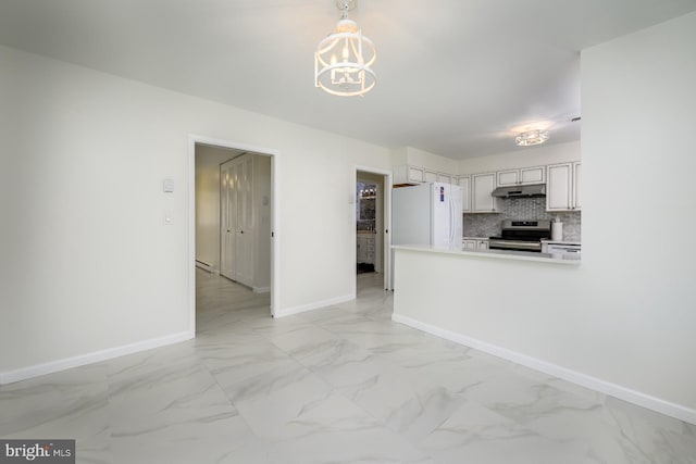 kitchen featuring tasteful backsplash, under cabinet range hood, stainless steel electric range oven, freestanding refrigerator, and marble finish floor