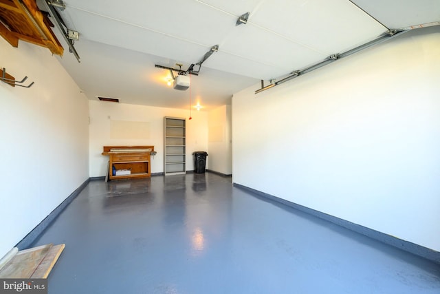 garage with a garage door opener and baseboards