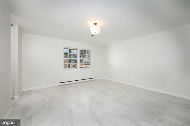 unfurnished room with marble finish floor, a baseboard heating unit, and baseboards