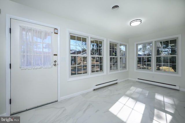 unfurnished sunroom featuring a baseboard heating unit, baseboard heating, and visible vents