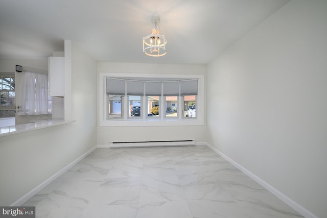 unfurnished room featuring baseboards, baseboard heating, marble finish floor, and an inviting chandelier