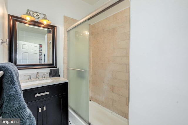 full bathroom featuring vanity and a tile shower