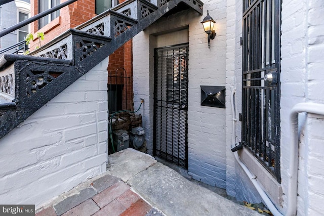 doorway to property with brick siding