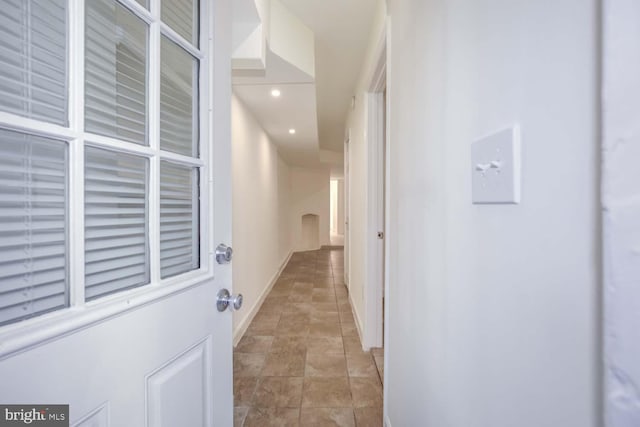 hallway featuring recessed lighting and baseboards