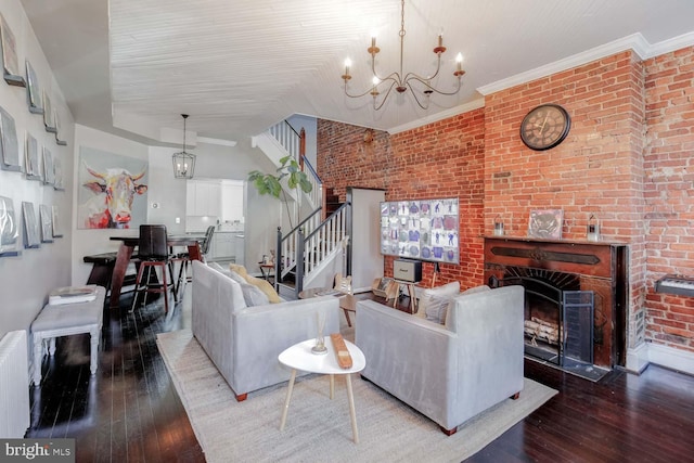 living room with radiator, brick wall, stairs, hardwood / wood-style flooring, and a notable chandelier