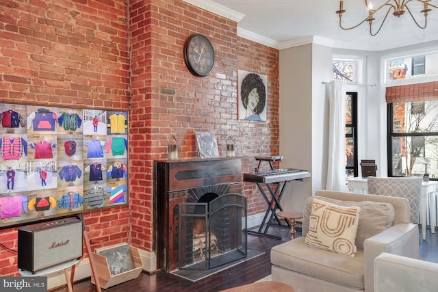 living area featuring crown molding, wood finished floors, and brick wall