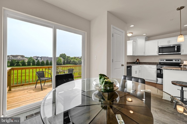 dining room featuring dark wood-type flooring, recessed lighting, and visible vents