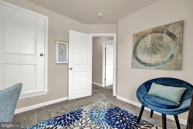 living area with baseboards and carpet floors