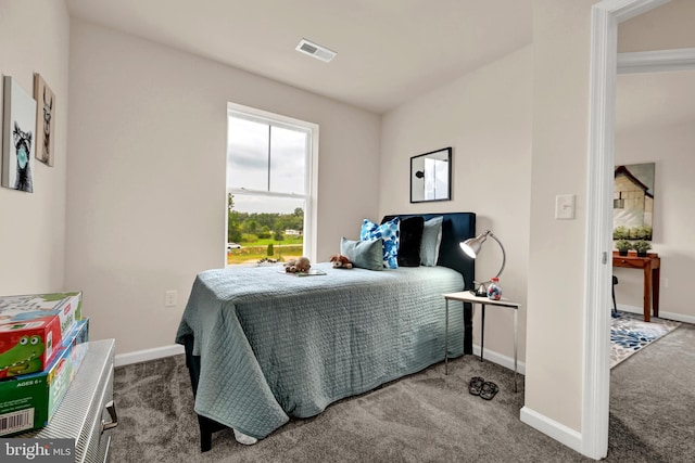 carpeted bedroom with visible vents and baseboards