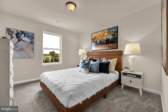 carpeted bedroom featuring visible vents and baseboards