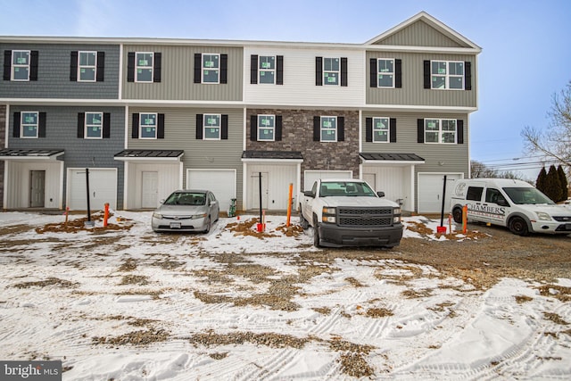 multi unit property featuring an attached garage