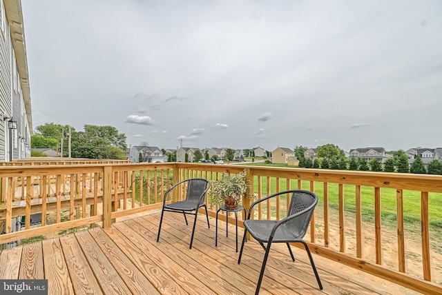 wooden terrace featuring a yard and a residential view