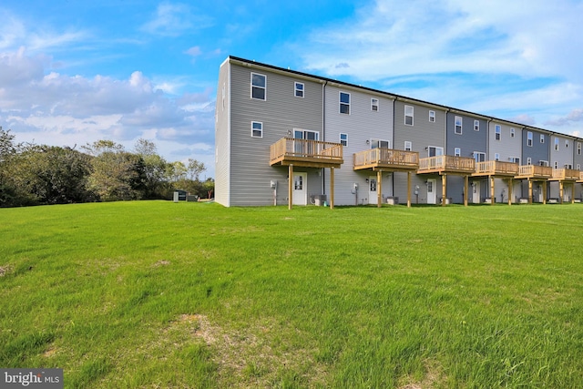 rear view of property featuring a lawn