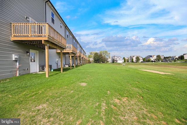 view of yard featuring a deck and cooling unit