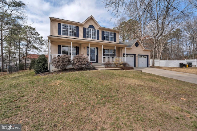 colonial house with a front lawn, fence, covered porch, a garage, and driveway