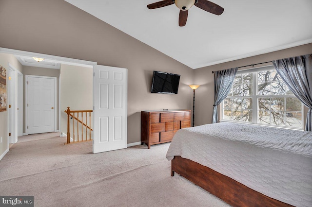 carpeted bedroom with ceiling fan, baseboards, and lofted ceiling