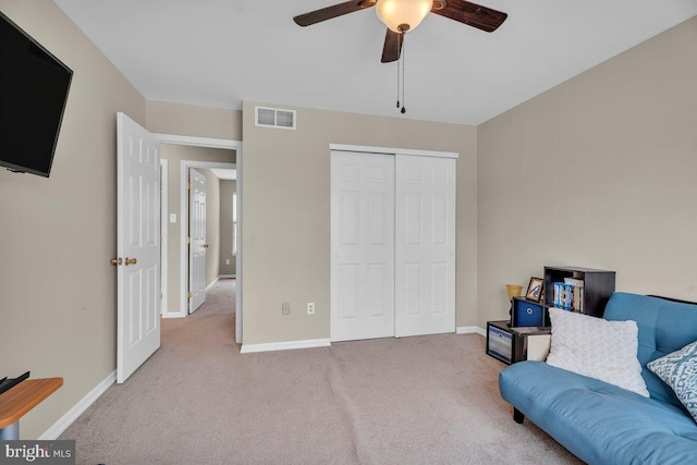 sitting room with visible vents, baseboards, carpet, and a ceiling fan