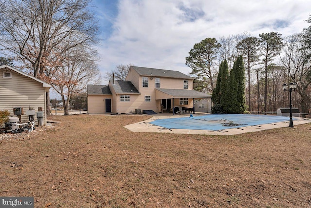 view of pool with a covered pool, a patio, and a lawn