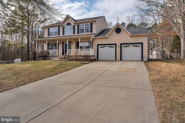 colonial house with a front lawn, driveway, a porch, fence, and a garage