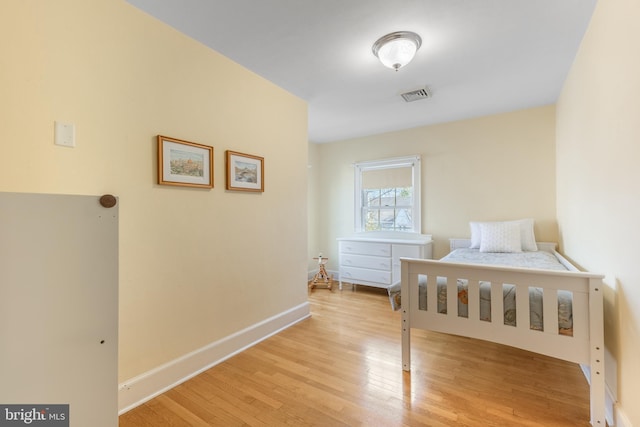 bedroom with visible vents, baseboards, and light wood-style floors