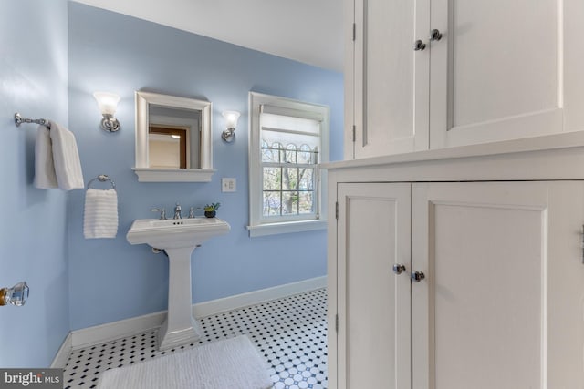 bathroom with tile patterned floors and baseboards