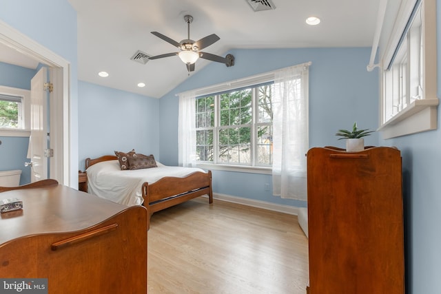 bedroom featuring vaulted ceiling, baseboards, visible vents, and light wood finished floors