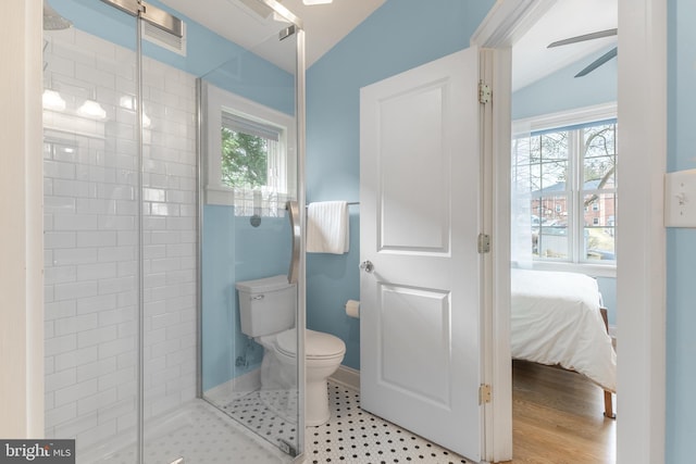 ensuite bathroom featuring ensuite bath, lofted ceiling, ceiling fan, a shower stall, and toilet