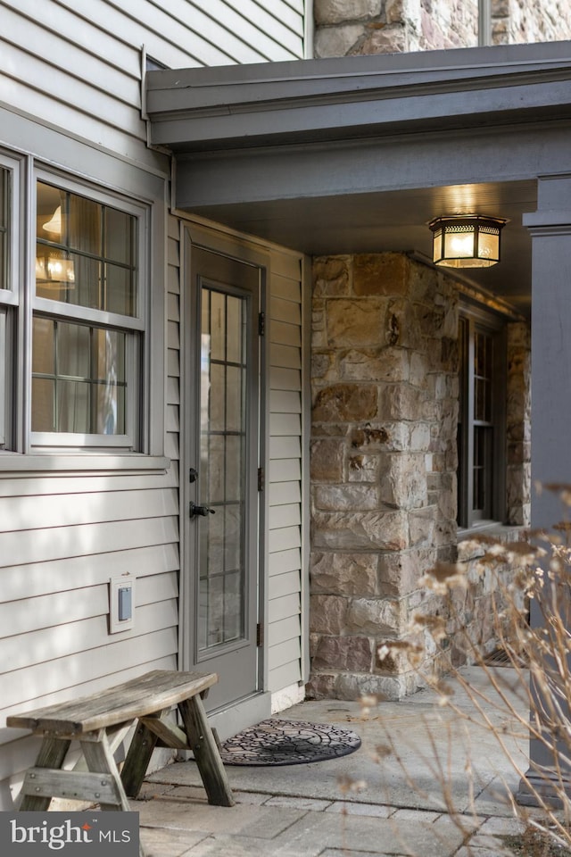 entrance to property with stone siding