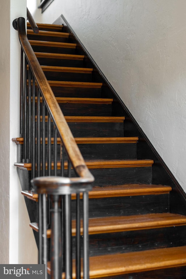 stairway with a textured wall