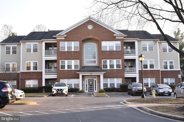 view of building exterior featuring uncovered parking