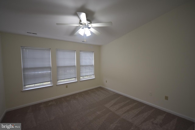 spare room featuring visible vents, baseboards, ceiling fan, and carpet floors