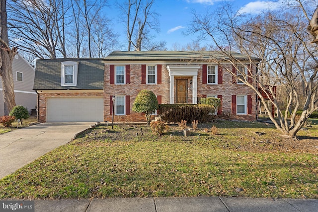 split foyer home featuring brick siding, driveway, a front yard, and a garage