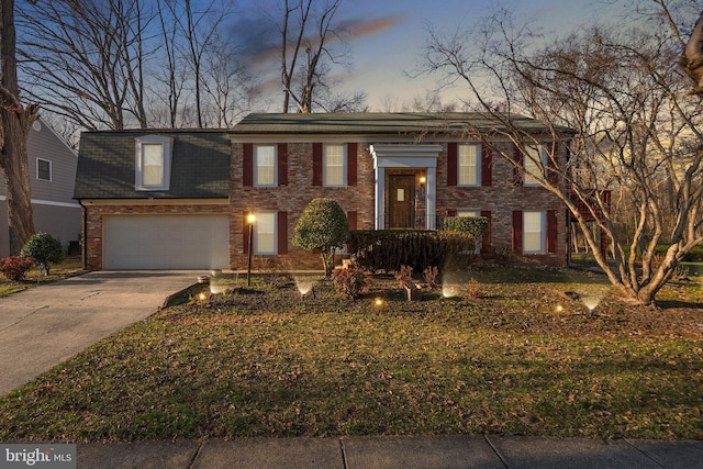 split foyer home with concrete driveway, brick siding, and a garage